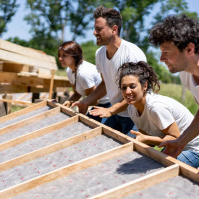 Latin american volunteers working hard at a charity construction project - Charity and relief concepts